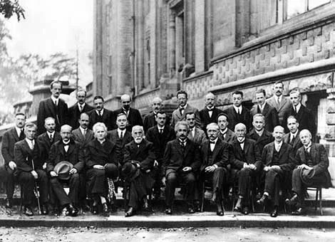 Participants in the Fifth Solvay Conference on Physics, Brussels, October 1927, arranged in three rows outside a building.